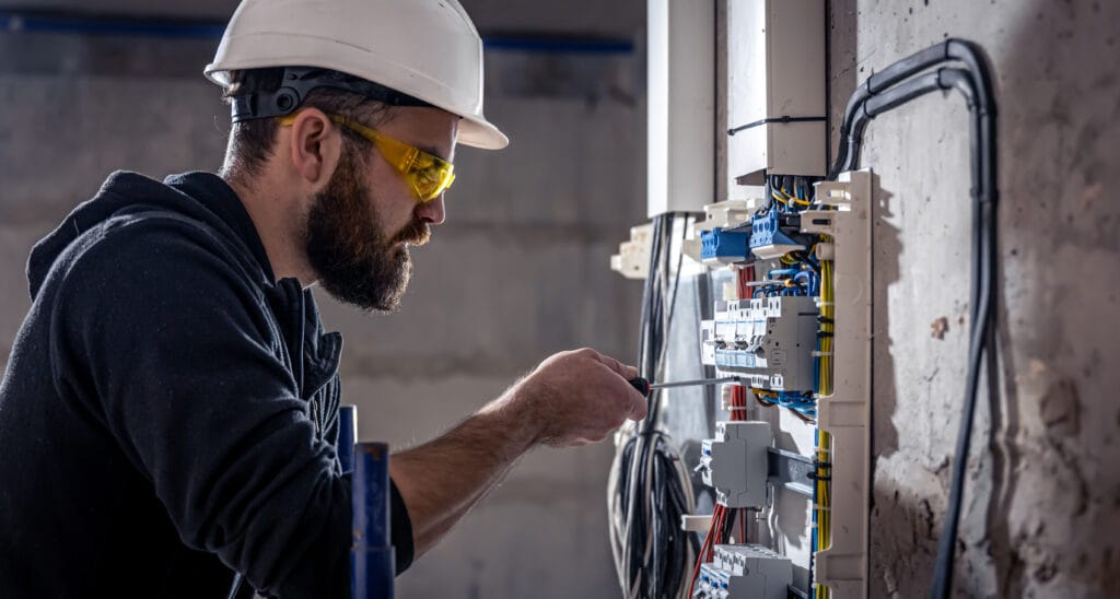 electrician working on electrical panel